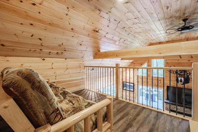 sitting room with wooden ceiling, wooden walls, wood finished floors, ceiling fan, and lofted ceiling