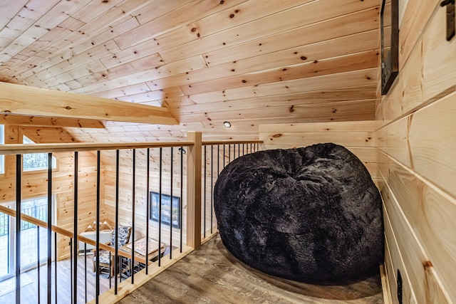 living area with wood ceiling, wood walls, and wood finished floors