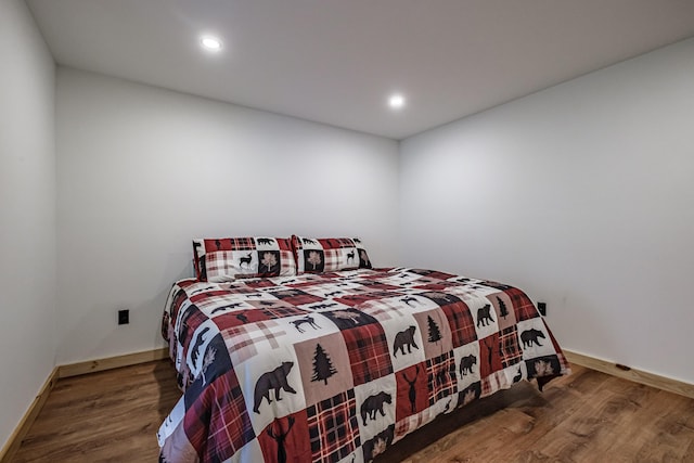bedroom with wood finished floors, recessed lighting, and baseboards