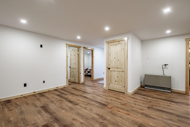 finished basement with wood finished floors, recessed lighting, and baseboards