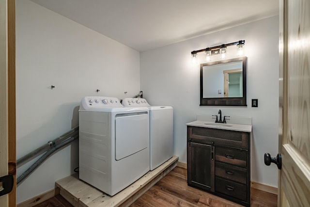 bathroom featuring independent washer and dryer, wood finished floors, vanity, and baseboards