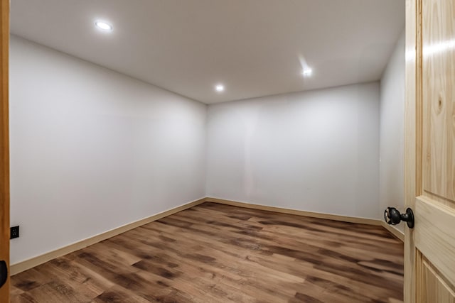 empty room with wood finished floors, recessed lighting, and baseboards