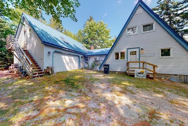 352 Georges Pond Rd, Franklin, ME 04634 - rear view of house featuring metal roof, stairs, a chimney, and a standing seam roof