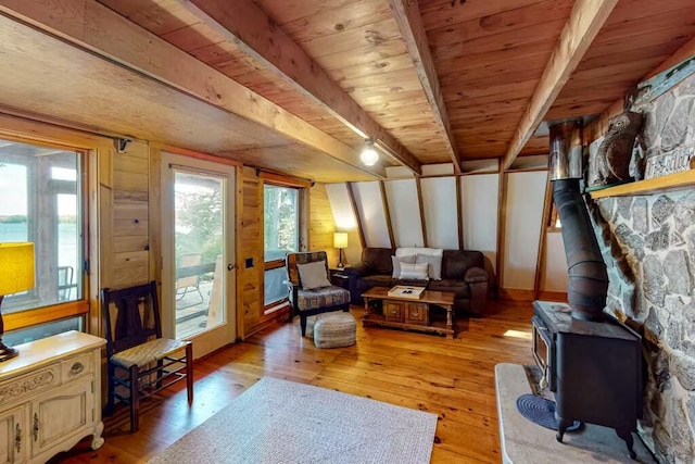 352 Georges Pond Rd, Franklin, ME 04634 - living area with light wood-type flooring, a wood stove, wood ceiling, and beamed ceiling