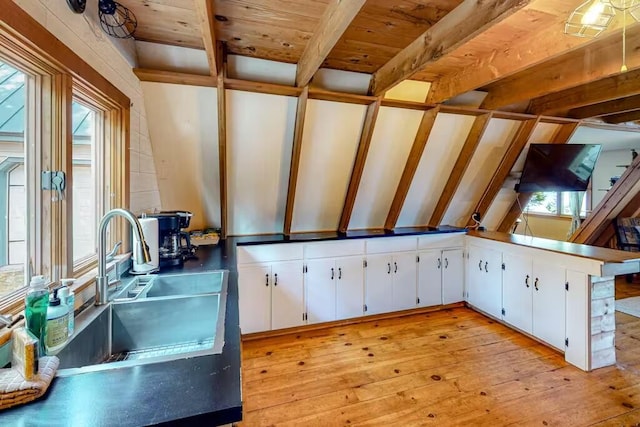 352 Georges Pond Rd, Franklin, ME 04634 - kitchen with light wood finished floors, white cabinets, beamed ceiling, wooden ceiling, and a sink