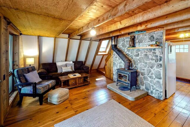 352 Georges Pond Rd, Franklin, ME 04634 - living area with a wood stove, hardwood / wood-style floors, and wood ceiling