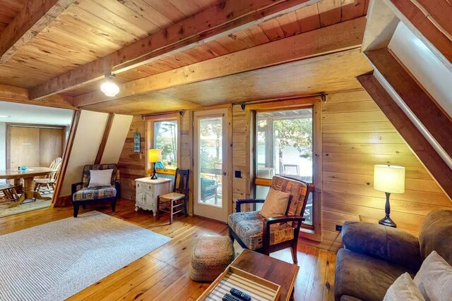 352 Georges Pond Rd, Franklin, ME 04634 - living room with beamed ceiling, wood-type flooring, wood ceiling, and wooden walls