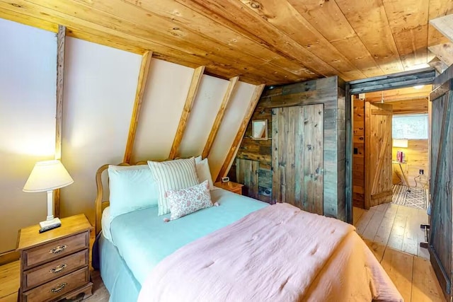 352 Georges Pond Rd, Franklin, ME 04634 - bedroom featuring wood walls, wooden ceiling, wood-type flooring, and a closet