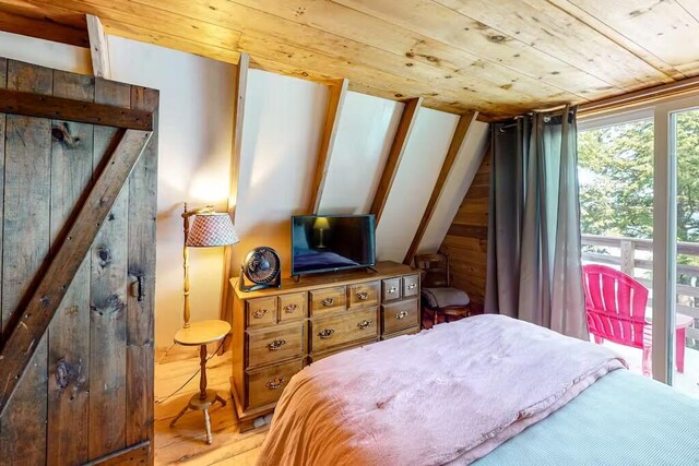 352 Georges Pond Rd, Franklin, ME 04634 - bedroom with wooden ceiling, wood finished floors, wooden walls, and lofted ceiling