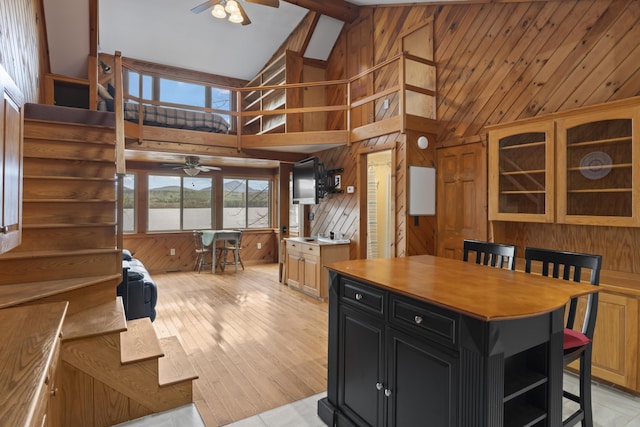 62 Lady Slipper Ln, Weld, ME 04285 - kitchen with ceiling fan, dark cabinetry, wooden walls, high vaulted ceiling, and open shelves