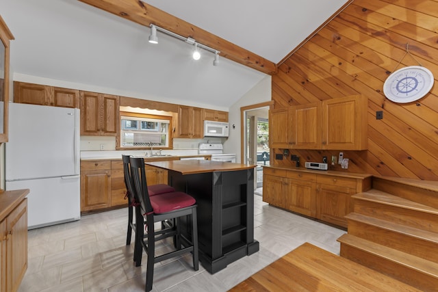 62 Lady Slipper Ln, Weld, ME 04285 - kitchen with white appliances, rail lighting, lofted ceiling, a sink, and brown cabinets