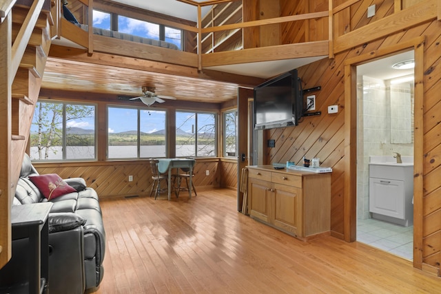 62 Lady Slipper Ln, Weld, ME 04285 - living room with ceiling fan, light wood-style floors, plenty of natural light, and wood walls