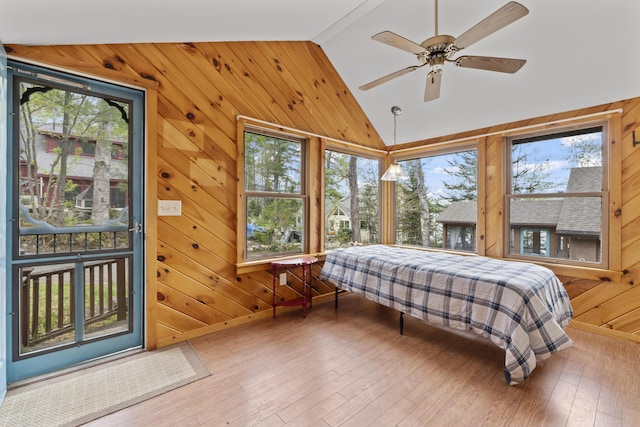 62 Lady Slipper Ln, Weld, ME 04285 - bedroom with lofted ceiling, multiple windows, wood walls, wood finished floors, and a ceiling fan
