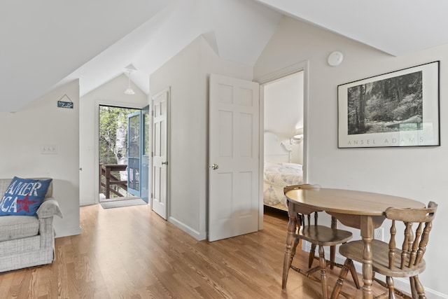 62 Lady Slipper Ln, Weld, ME 04285 - dining area featuring vaulted ceiling, wood finished floors, and baseboards