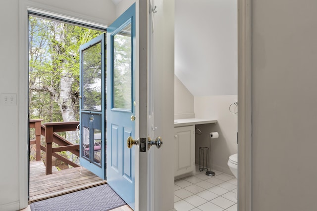 62 Lady Slipper Ln, Weld, ME 04285 - doorway with light tile patterned floors and vaulted ceiling