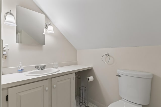 62 Lady Slipper Ln, Weld, ME 04285 - half bath with vaulted ceiling, toilet, vanity, tile patterned floors, and baseboards
