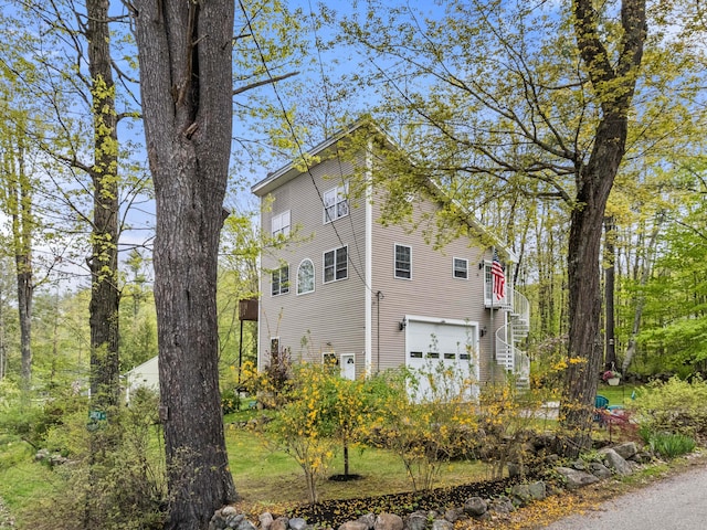 view of side of home featuring an attached garage