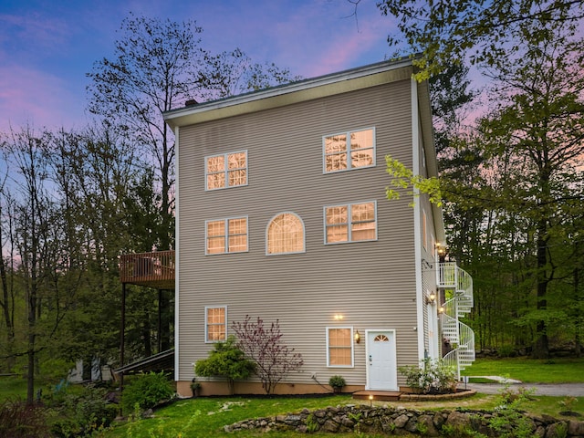 view of home's exterior featuring stairs and a yard
