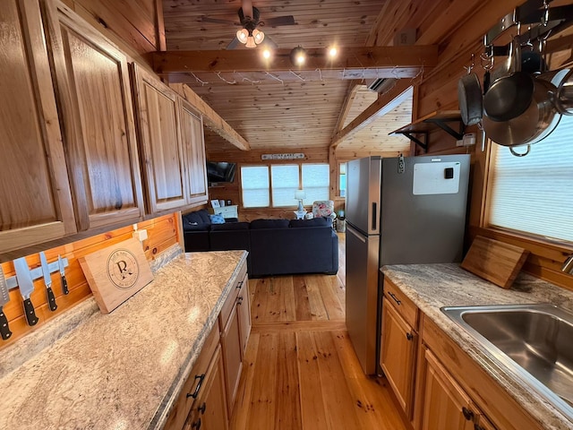 1270 Lakeview Dr Unit 21, China, ME 04358 - kitchen featuring light wood finished floors, a sink, wood ceiling, freestanding refrigerator, and beamed ceiling
