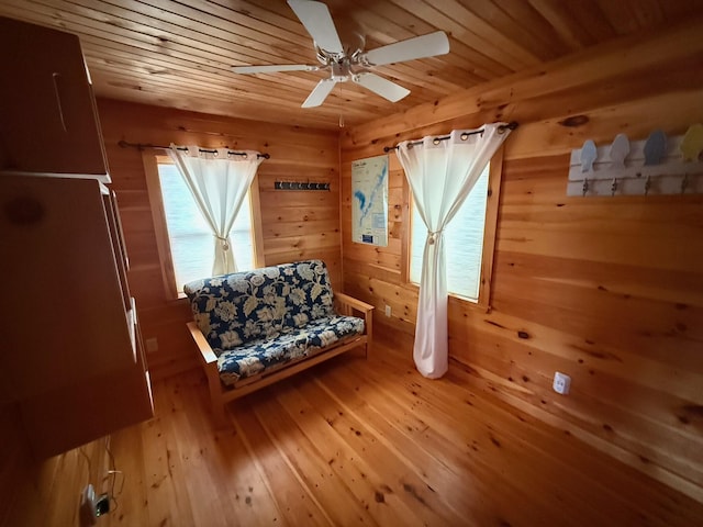 1270 Lakeview Dr Unit 21, China, ME 04358 - sitting room with wooden walls, wood-type flooring, wood ceiling, and a ceiling fan