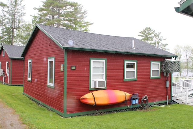 1270 Lakeview Dr Unit 21, China, ME 04358 - view of property exterior featuring roof with shingles, a lawn, and cooling unit