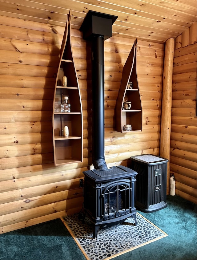 15 Miles Rd, Tremont, ME 04674 - detailed view of a wood stove, carpet floors, and log walls