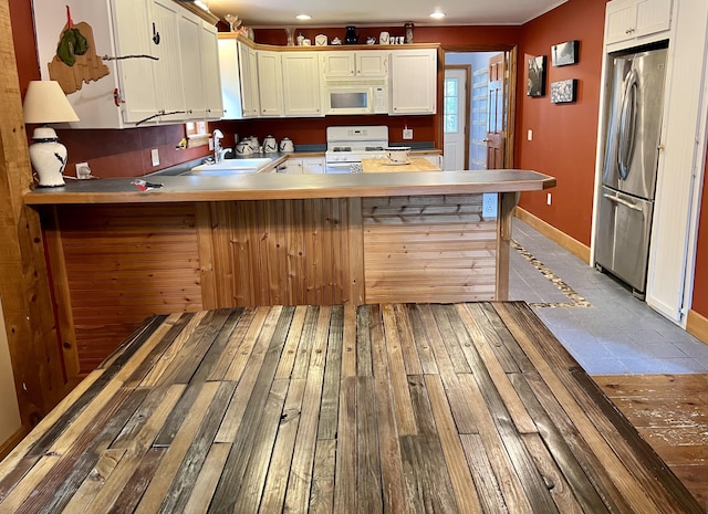 15 Miles Rd, Tremont, ME 04674 - kitchen with white appliances, a sink, baseboards, a peninsula, and recessed lighting