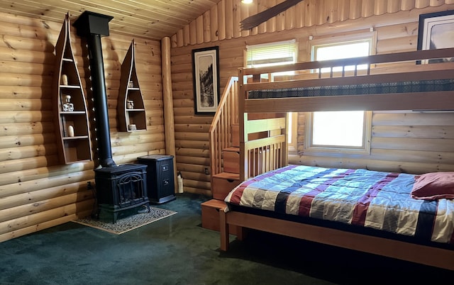 15 Miles Rd, Tremont, ME 04674 - carpeted bedroom with log walls, a wood stove, lofted ceiling, and wood ceiling