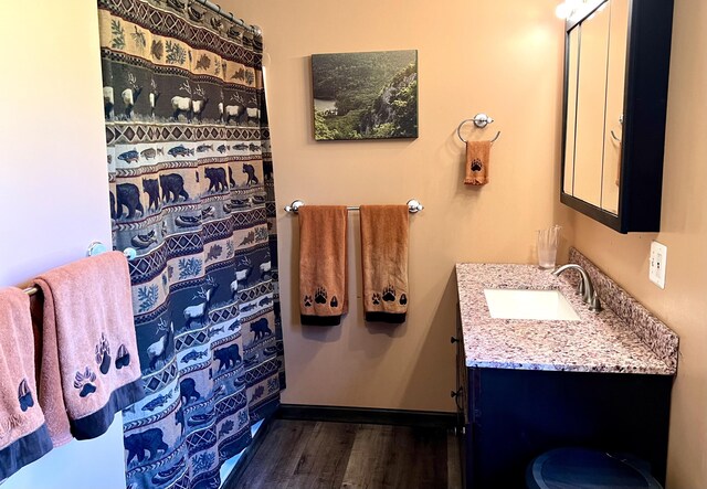 15 Miles Rd, Tremont, ME 04674 - full bathroom featuring wood finished floors, vanity, and a shower with curtain