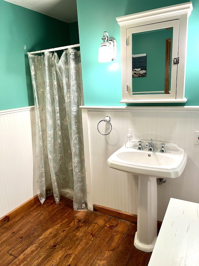 15 Miles Rd, Tremont, ME 04674 - full bathroom featuring wainscoting, wood finished floors, curtained shower, and a sink
