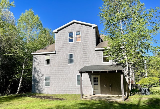 15 Miles Rd, Tremont, ME 04674 - back of property with a shingled roof and a yard