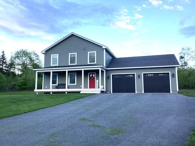 48 Mountain View Dr, Auburn, ME 04210 - view of front facade featuring asphalt driveway, a garage, a porch, and a front lawn