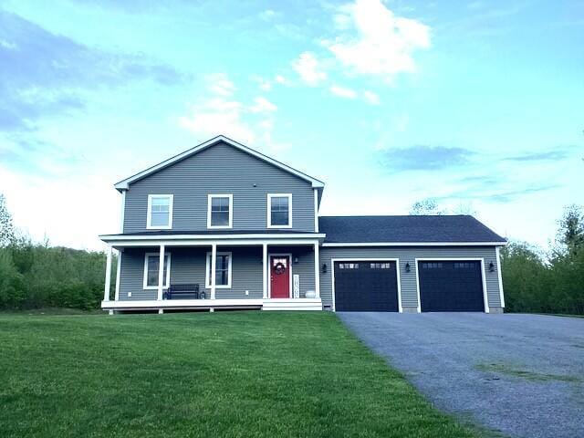 48 Mountain View Dr, Auburn, ME 04210 - view of front of property featuring a garage, asphalt driveway, covered porch, and a front lawn