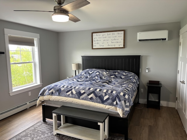 48 Mountain View Dr, Auburn, ME 04210 - bedroom featuring a wall unit AC, wood finished floors, baseboard heating, and ceiling fan