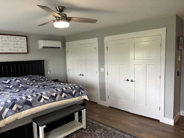 48 Mountain View Dr, Auburn, ME 04210 - bedroom featuring an AC wall unit, wood finished floors, ceiling fan, two closets, and baseboards