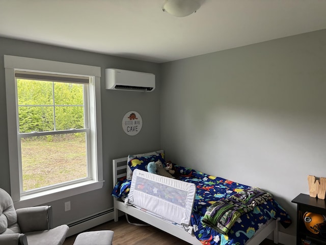 48 Mountain View Dr, Auburn, ME 04210 - bedroom featuring a wall mounted AC, a baseboard heating unit, and dark wood-type flooring