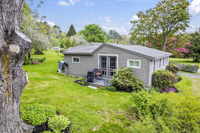 77 Main St, Raymond, ME 04071 - back of house with french doors, a yard, and view of scattered trees