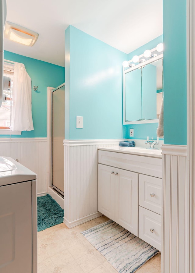 160 Rattlesnake Rd, Brownfield, ME 04010 - bathroom with washer / clothes dryer, a wainscoted wall, a stall shower, and vanity