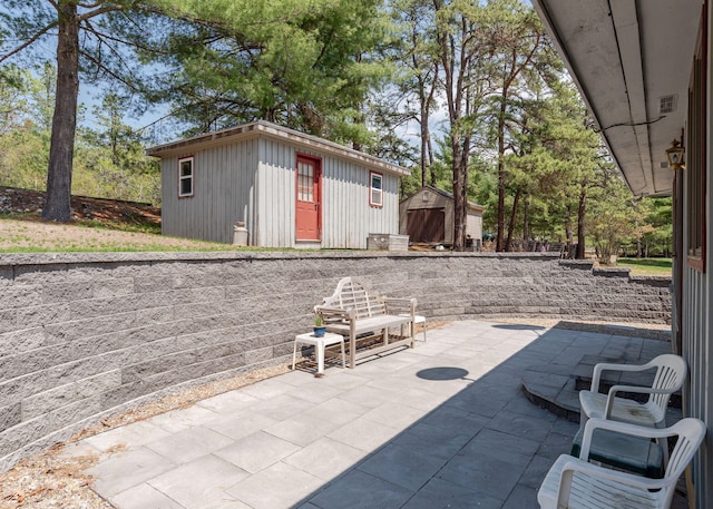 160 Rattlesnake Rd, Brownfield, ME 04010 - view of patio featuring an outbuilding and a storage unit