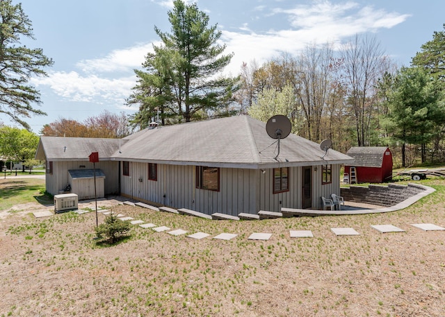 160 Rattlesnake Rd, Brownfield, ME 04010 - rear view of property with an outdoor structure, a storage unit, board and batten siding, and a jacuzzi