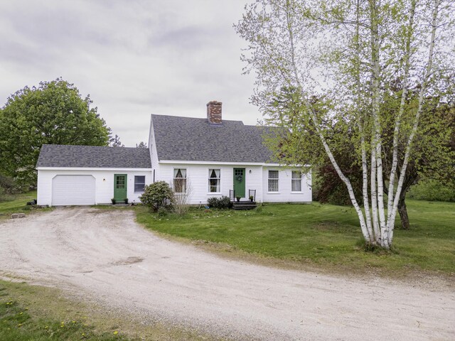 7 Salmon Run, Raymond, ME 04071 - view of front of home with a garage, dirt driveway, a chimney, a front yard, and a shingled roof