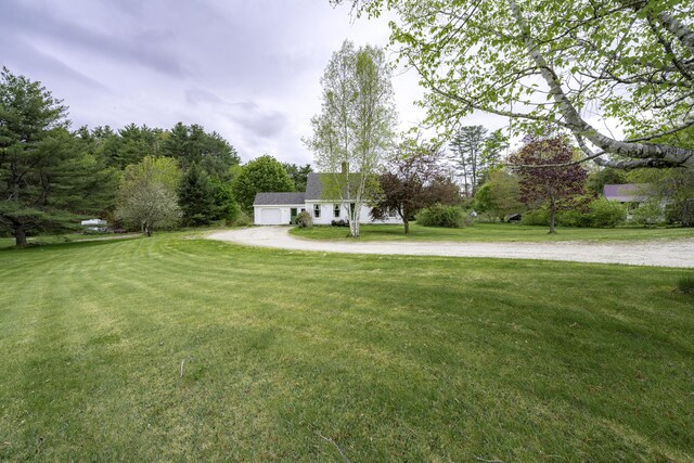 7 Salmon Run, Raymond, ME 04071 - view of grassy yard featuring a garage and driveway
