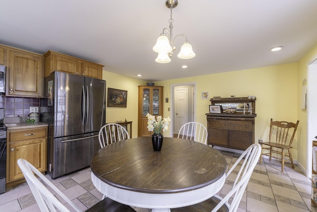 7 Salmon Run, Raymond, ME 04071 - dining room featuring a chandelier, recessed lighting, light tile patterned floors, and baseboards