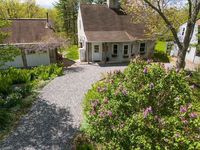 9 Juniper Ln, Damariscotta, ME 04543 - rear view of property featuring a chimney, roof with shingles, an outdoor structure, and gravel driveway