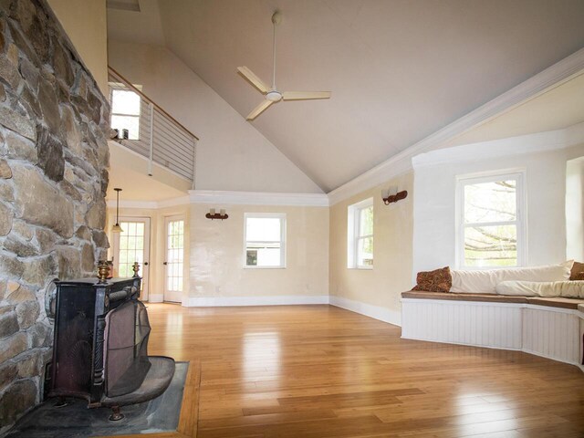 9 Juniper Ln, Damariscotta, ME 04543 - unfurnished living room with light wood finished floors, high vaulted ceiling, a ceiling fan, and baseboards