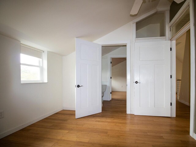 9 Juniper Ln, Damariscotta, ME 04543 - unfurnished bedroom with light wood-style floors, lofted ceiling, and baseboards