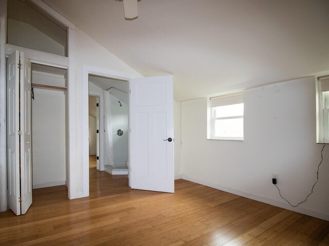 9 Juniper Ln, Damariscotta, ME 04543 - unfurnished bedroom featuring light wood-style flooring, baseboards, lofted ceiling, and a closet