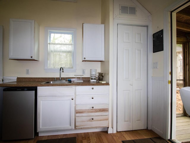 9 Juniper Ln, Damariscotta, ME 04543 - kitchen with a sink, dishwasher, wood finished floors, white cabinets, and dark countertops