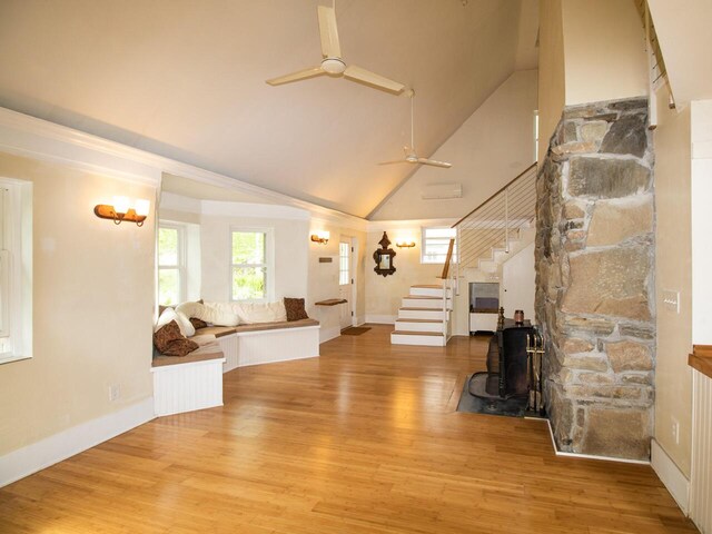 9 Juniper Ln, Damariscotta, ME 04543 - living area featuring stairway, ceiling fan, high vaulted ceiling, wood finished floors, and a wood stove