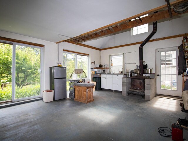 9 Juniper Ln, Damariscotta, ME 04543 - garage with freestanding refrigerator and a wood stove
